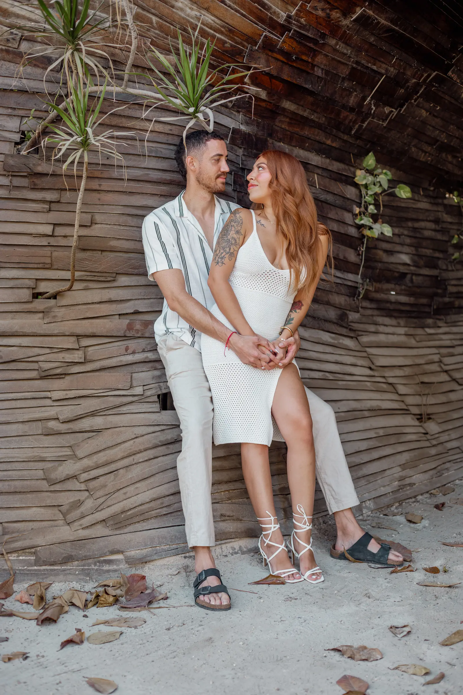 Romantic couple walking barefoot along Tulum beach captured by local Tulum photographer
