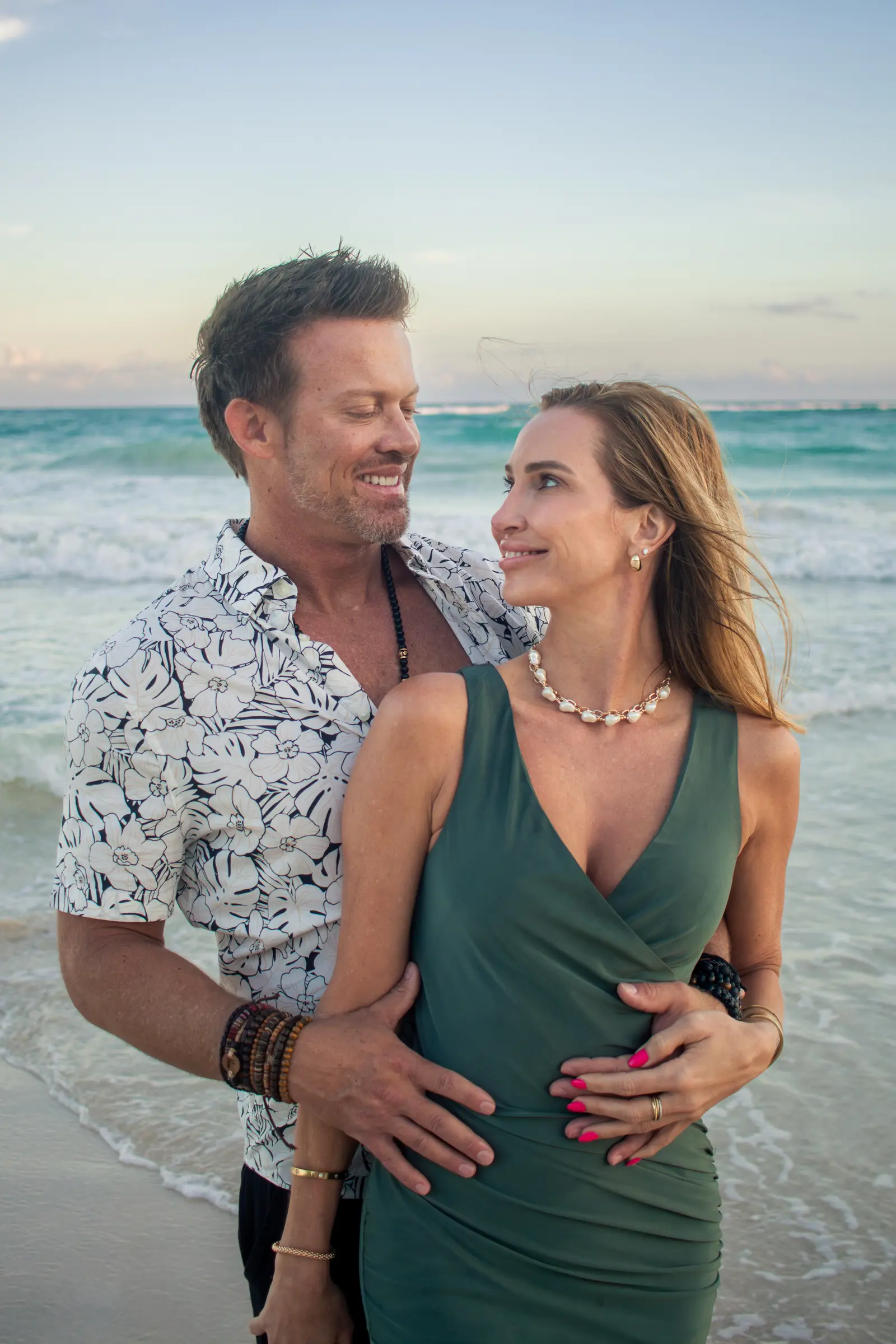 Playful couple running on Tulum beach captured candidly by local photographer