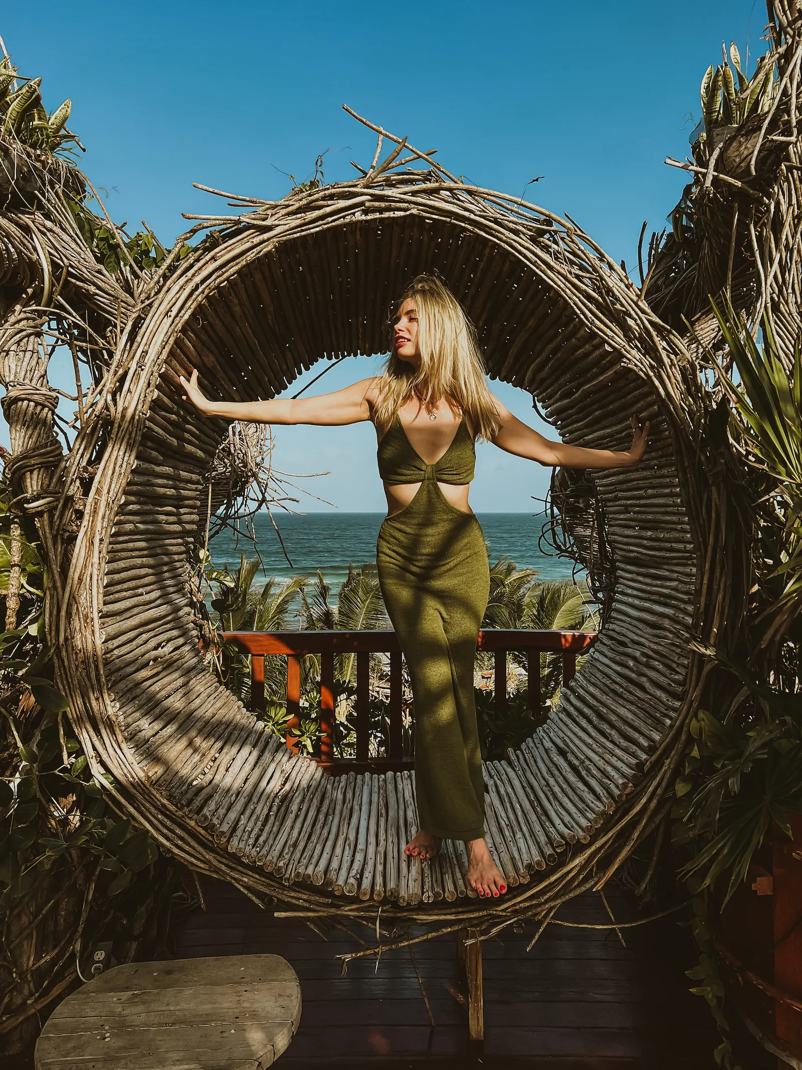 Stylish solo traveler posing during professional photoshoot on Tulum beach Mexico
