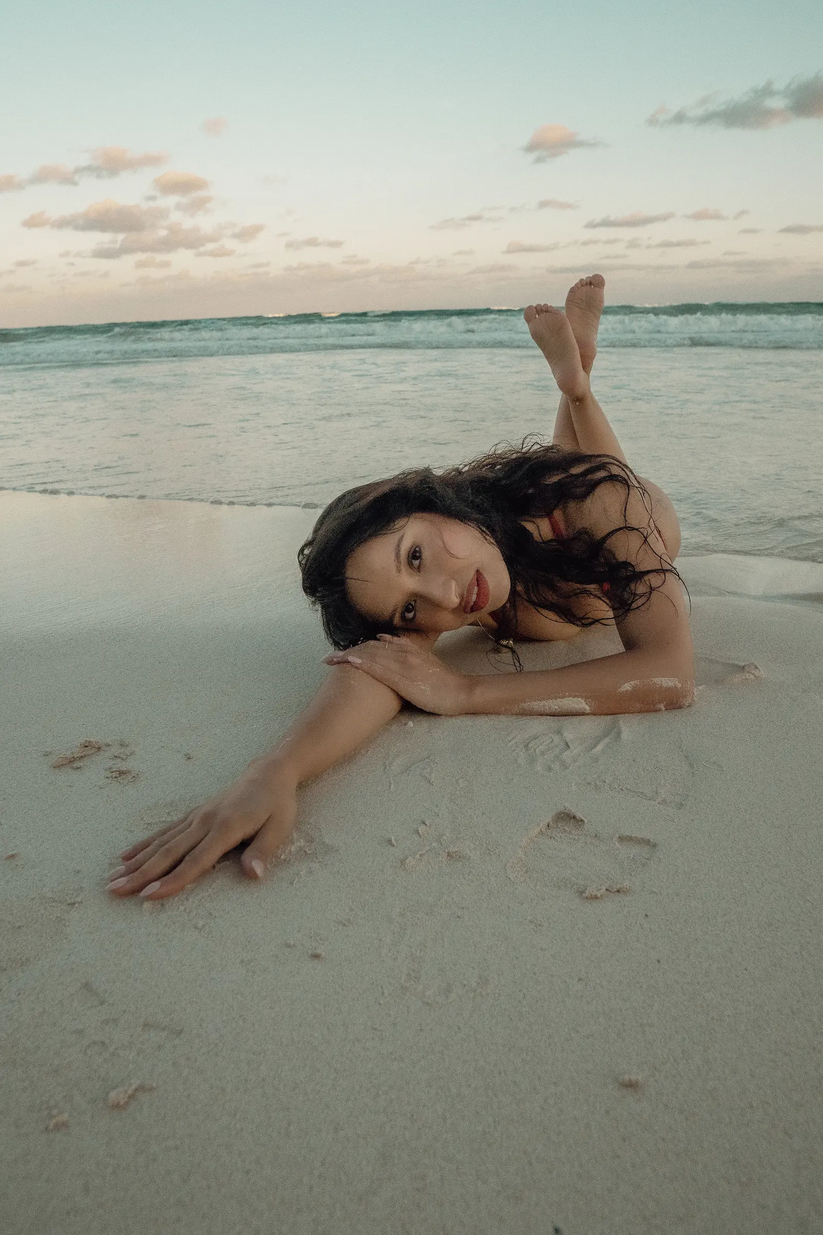 Woman walking along Tulum shoreline during romantic solo traveler photoshoot at sunset