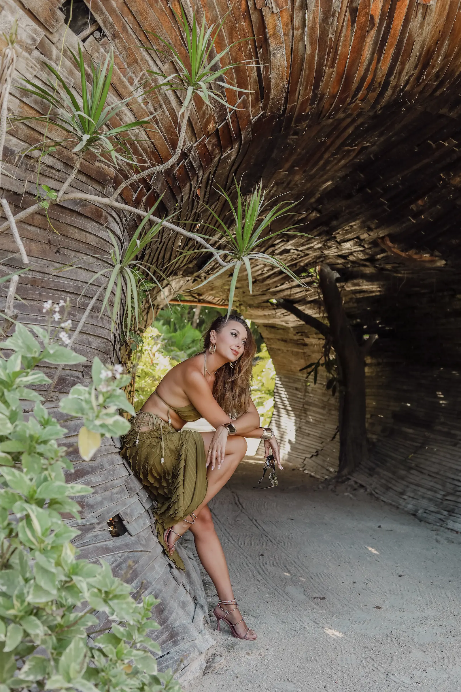 Joyful woman laughing during relaxed Tulum beach photoshoot with natural poses